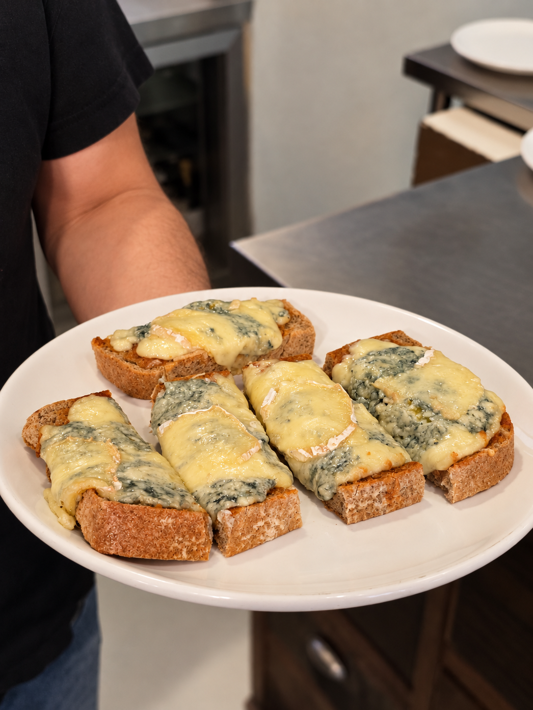 Freshly served cheese-topped tartines at Le Bistro.